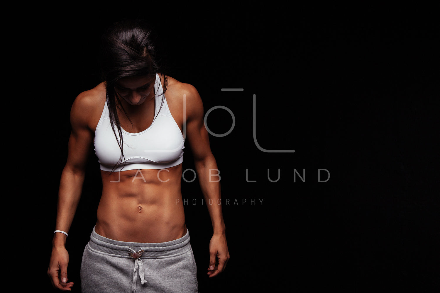 Young Muscular Woman with Six Pack Abs