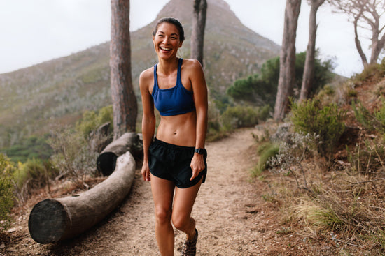 Premium Photo  Portrait adult asian woman trail runner with running vest  doing trail running training in the forest park