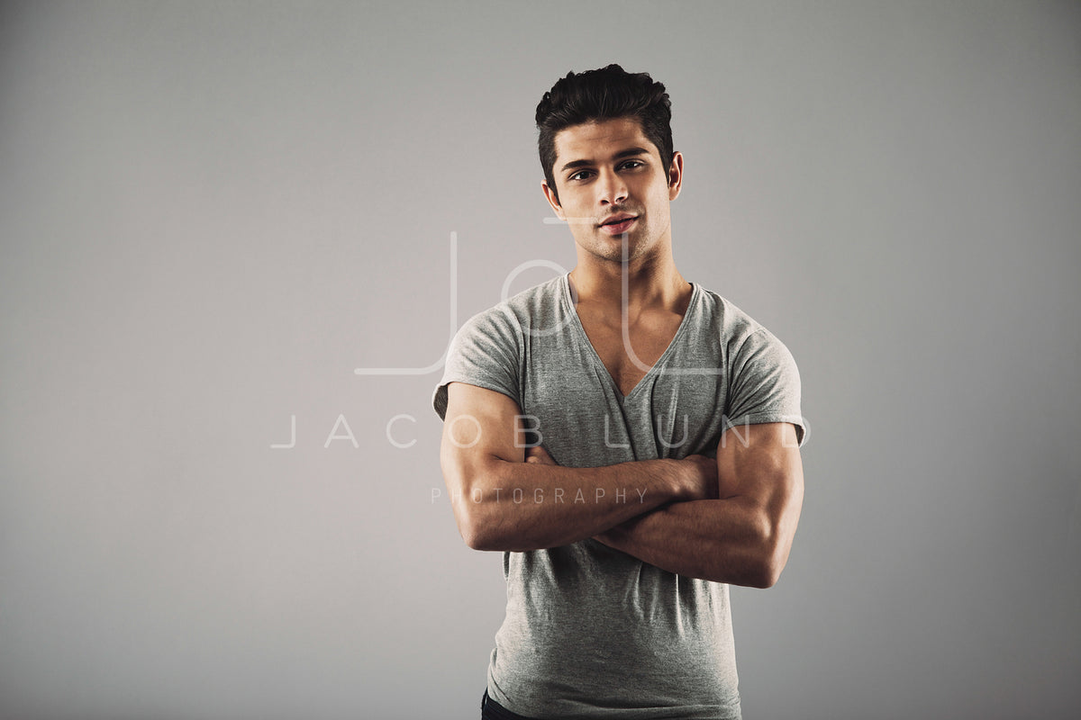 Young muscular man posing against grey background – Jacob Lund ...
