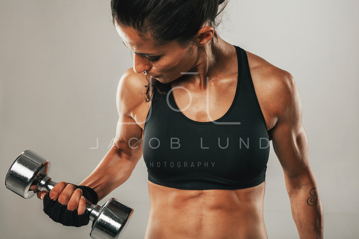 Strong female athlete lifting dumbbell – Jacob Lund Photography Store-  premium stock photo