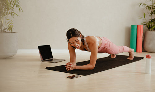 Premium Photo  Yoga lessons online positive yoga girl doing morning  practice in front of laptop at home