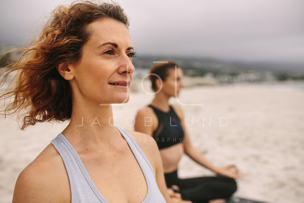 Sports woman doing yoga along the beach – Jacob Lund Photography Store-  premium stock photo