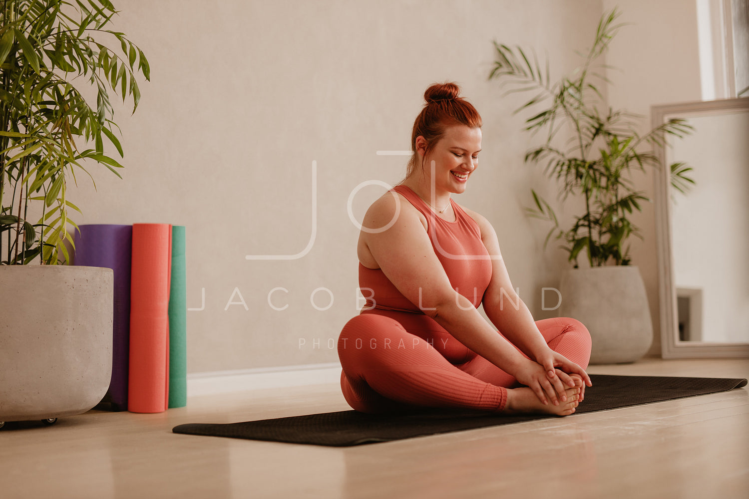 Woman doing yoga workout at fitness studio – Jacob Lund