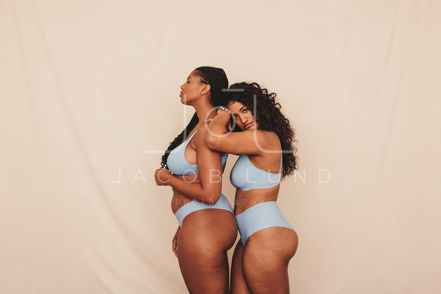 Two female friends standing in blue underwear in a studio – Jacob