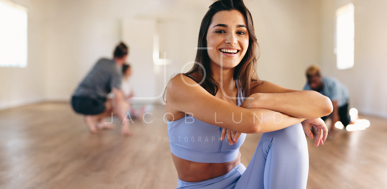 Female yoga instructor standing in a fitness studio – Jacob Lund  Photography Store- premium stock photo