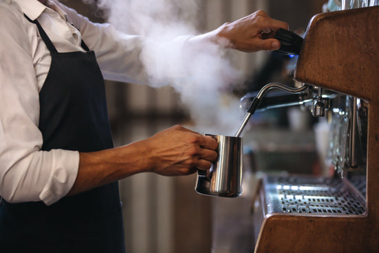 Smiling barista making espresso with a coffee maker – Jacob Lund  Photography Store- premium stock photo