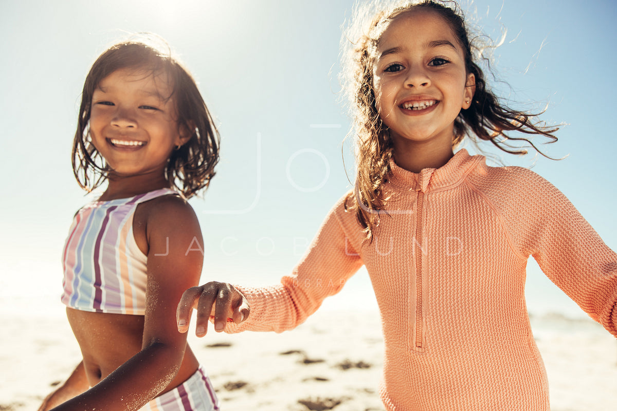 Active little girl playing and having fun at the beach – Jacob Lund  Photography Store- premium stock photo