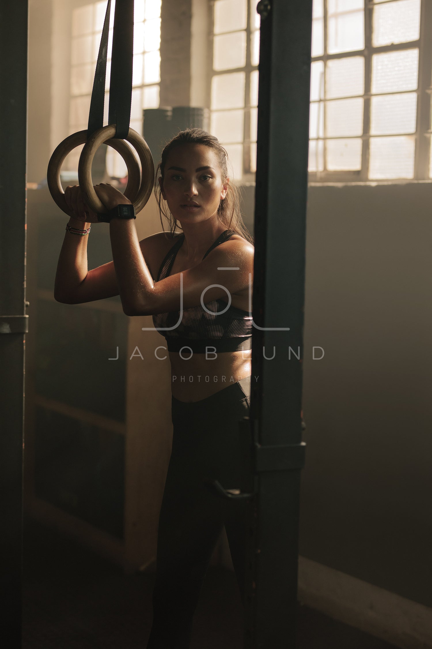 Fitness woman exercising with gymnastic rings Stock Photo by jacoblund