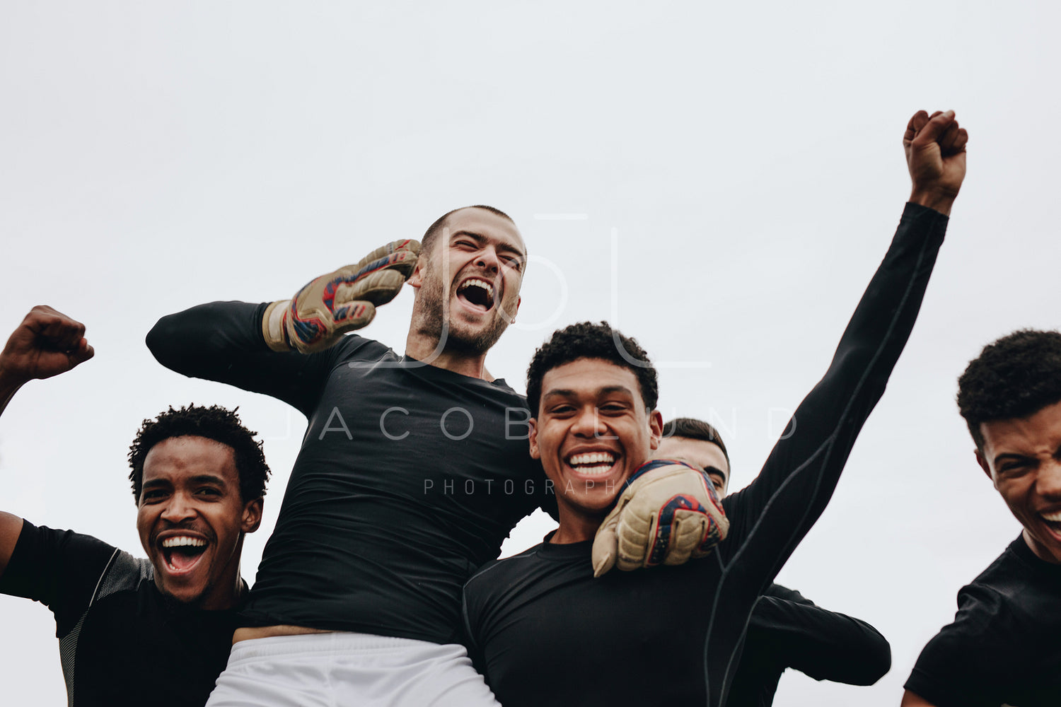 Football players screaming in joy celebrating a win – Jacob Lund  Photography Store- premium stock photo