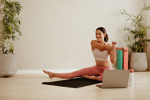 Woman doing yoga workout at fitness studio – Jacob Lund