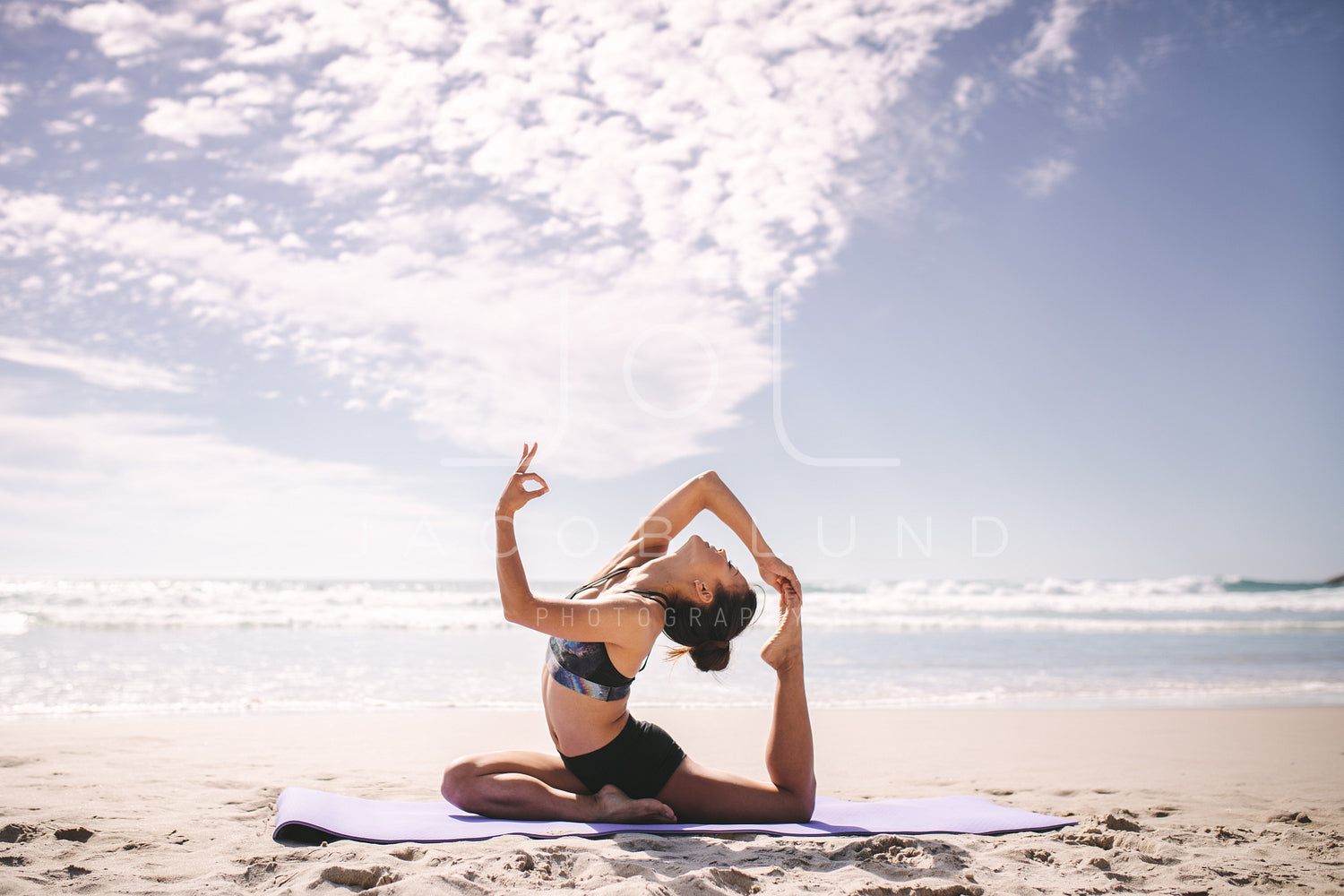 Sunset meditation. Young active woman stretching in yoga pose on sea beach  to keep fit and health. Healthy lifestyle, flexibility training, sport  activity in sport camp on summer family holiday. Stock Photo |