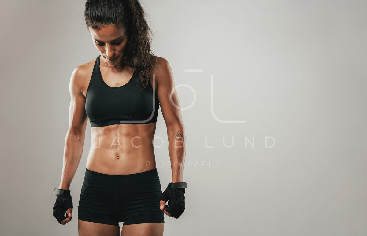 Muscular female athlete exercising with gymnast rings – Jacob Lund  Photography Store- premium stock photo