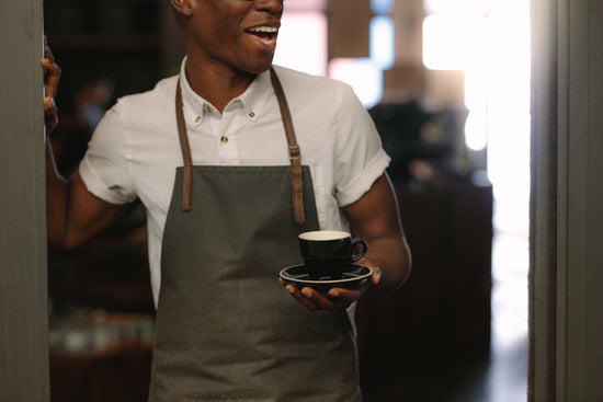 Smiling barista making espresso with a coffee maker – Jacob Lund  Photography Store- premium stock photo