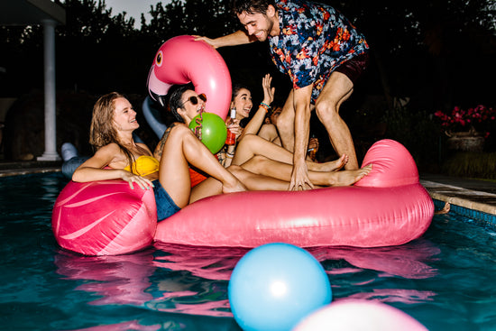 Happy people enjoying swimming pool party - UpLabs