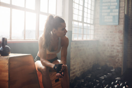 Fitness female taking a break from intense workout at the gym – Jacob Lund  Photography Store- premium stock photo