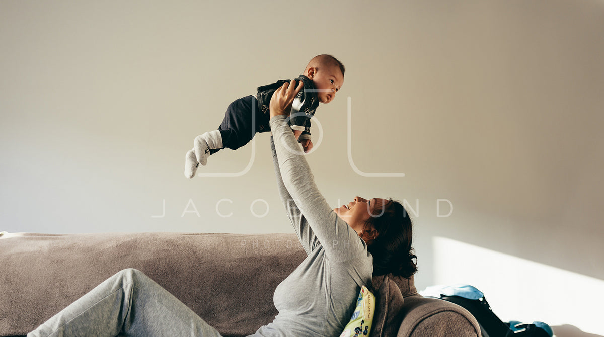 Confident pregnant woman embracing her baby bump in the third trimeste –  Jacob Lund Photography Store- premium stock photo