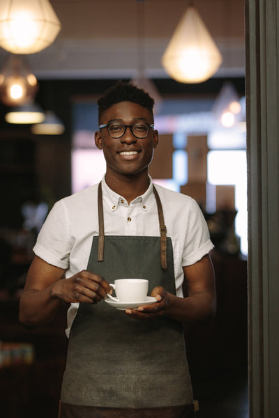 Smiling barista making espresso with a coffee maker – Jacob Lund  Photography Store- premium stock photo