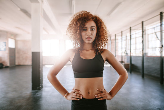 Fit young woman standing in gym – Jacob Lund Photography Store- premium  stock photo
