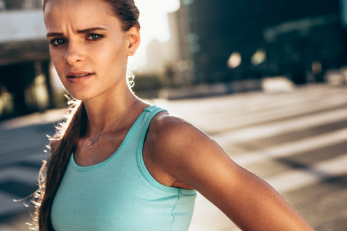 Premium Photo  Portrait of sportswoman smiling outdoors in morning. female  in running outfit standing outdoors in city.