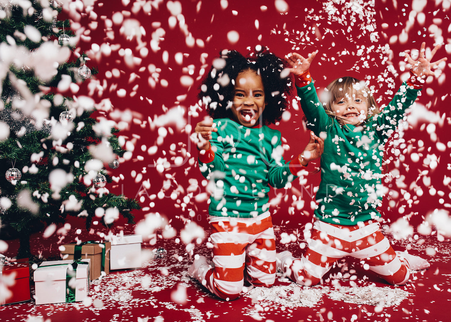 a) Children play with artificial snowflakes on Christmas