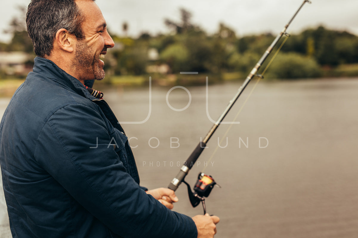Man Fishing With Rod On The Lake In Spring Stock Photo - Download Image Now  - Adult, Adults Only, Copy Space - iStock