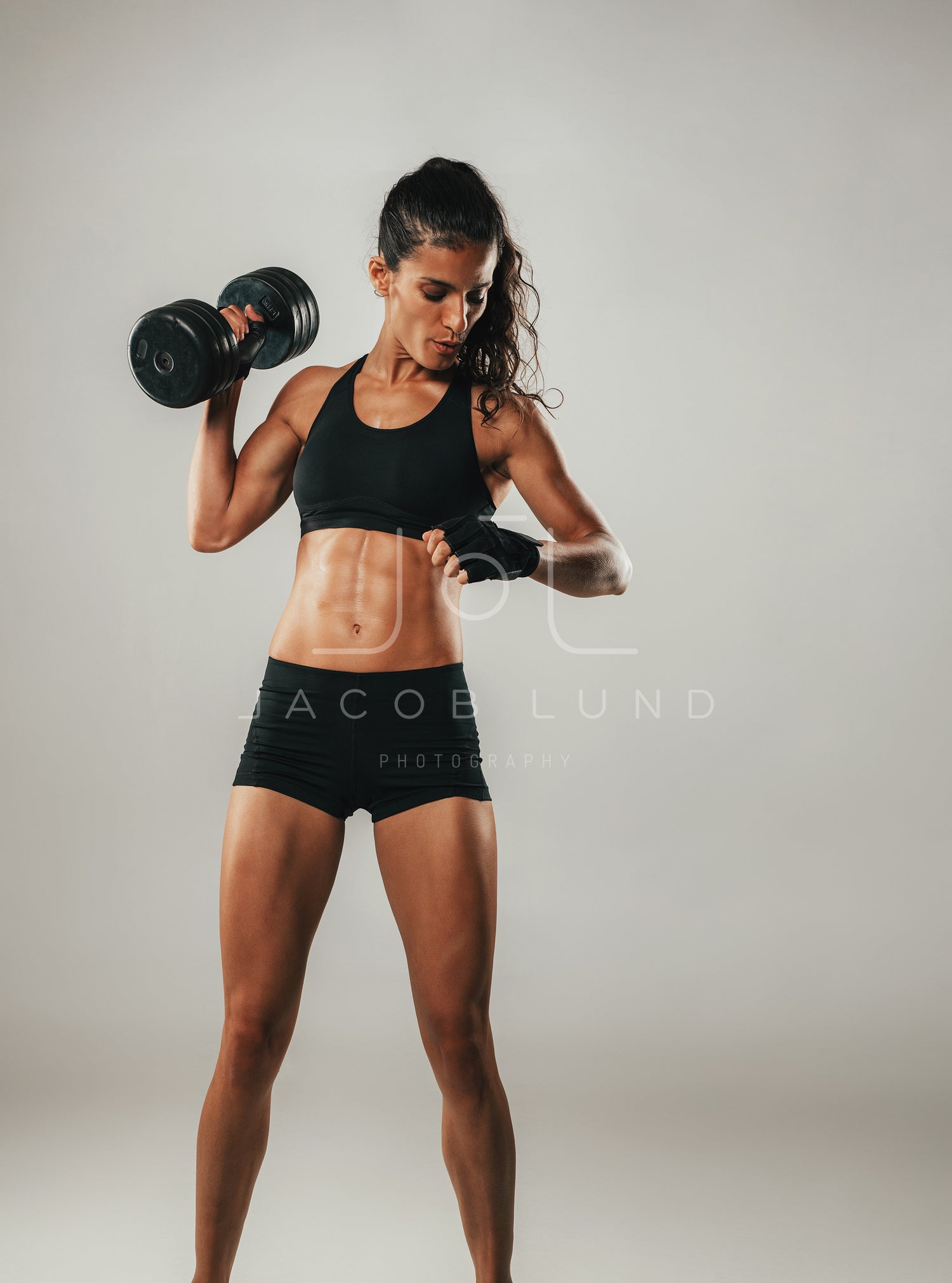Strong female athlete lifting dumbbell – Jacob Lund Photography Store-  premium stock photo