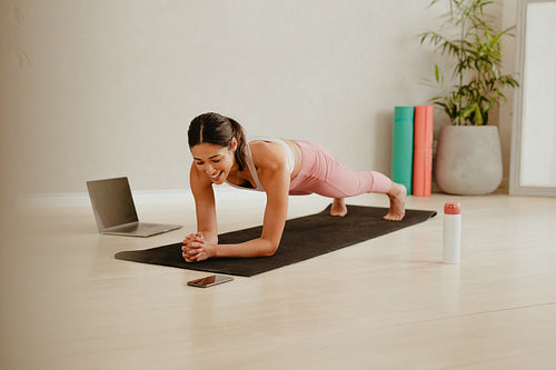 Premium Photo  Young plus size woman sitting over a yoga mat while doing  training at home online with a laptop online course concept copy space  image workout at home to lose