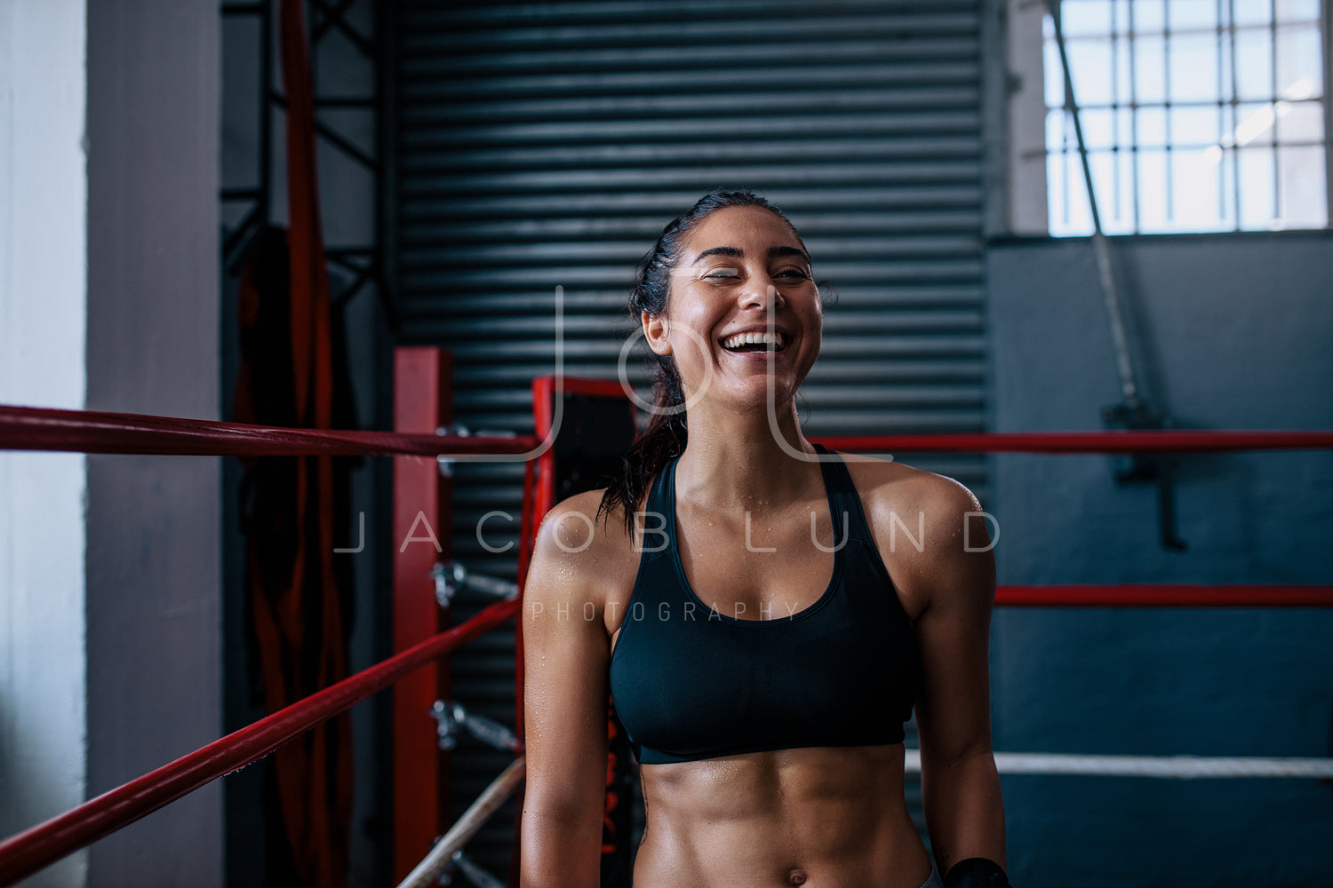 Young Female Boxer in Boxing Ring with Sports Bra