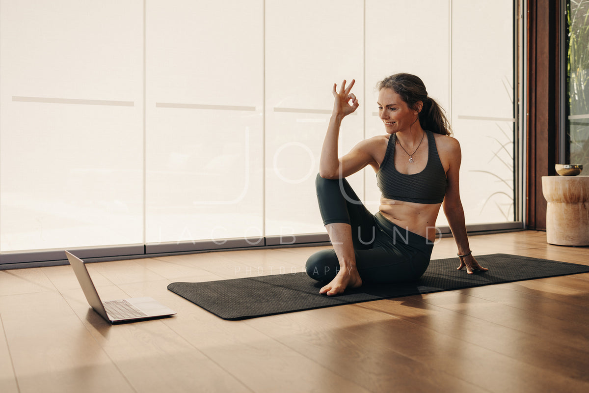 Cheerful senior woman doing an ok gesture during a yoga class – Jacob Lund  Photography Store- premium stock photo