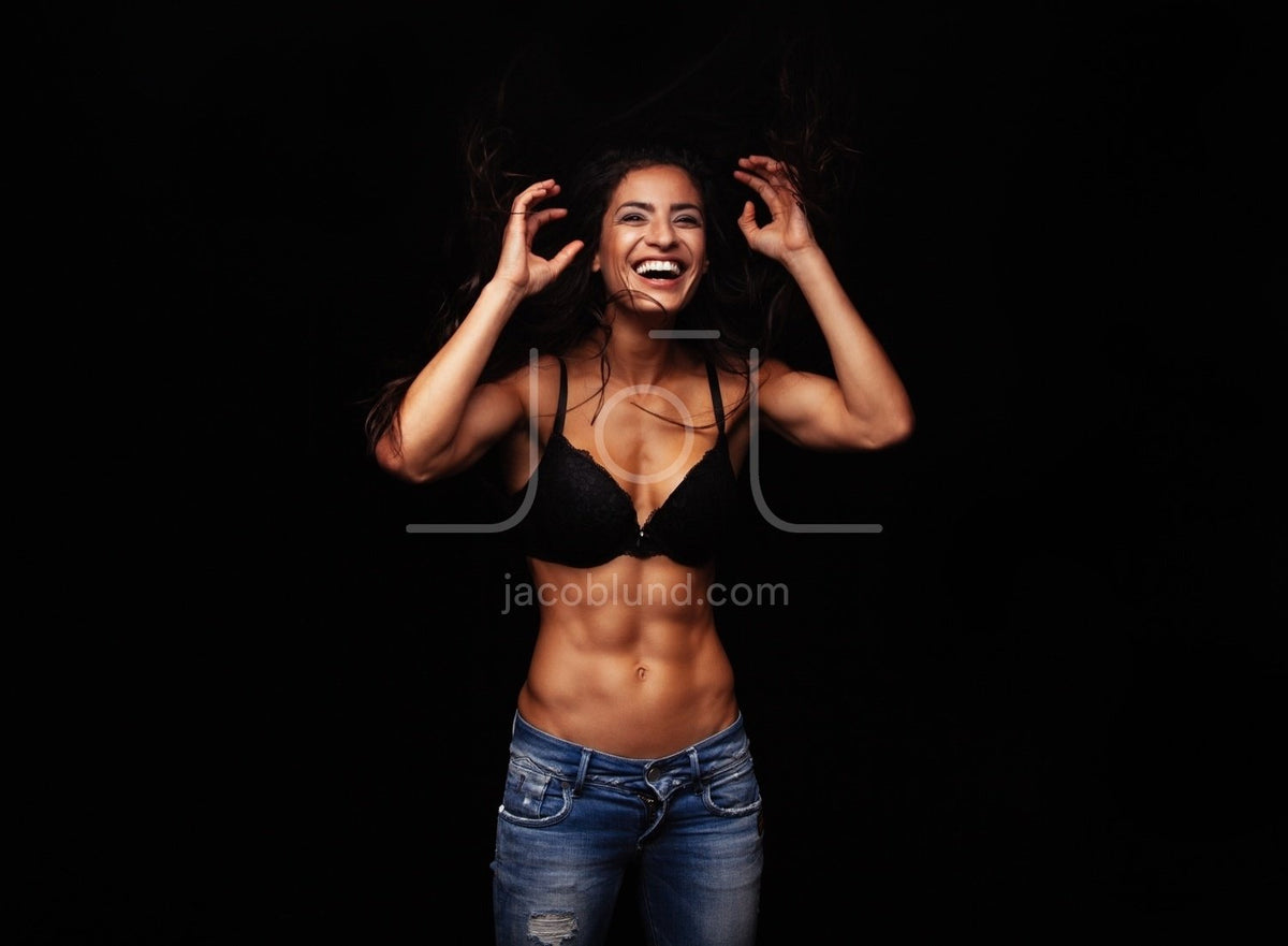 Happy young woman wearing bra and jeans, Stock Photo, Picture And