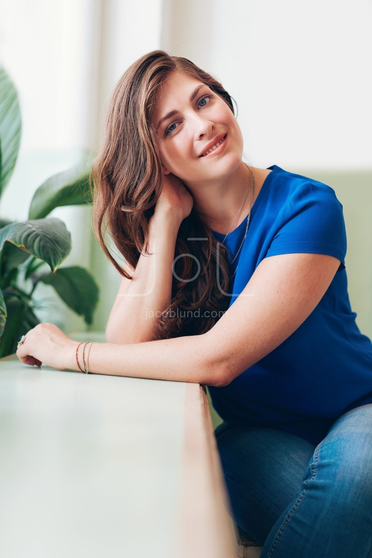 Attractive young woman sitting at a table – Jacob Lund Photography ...