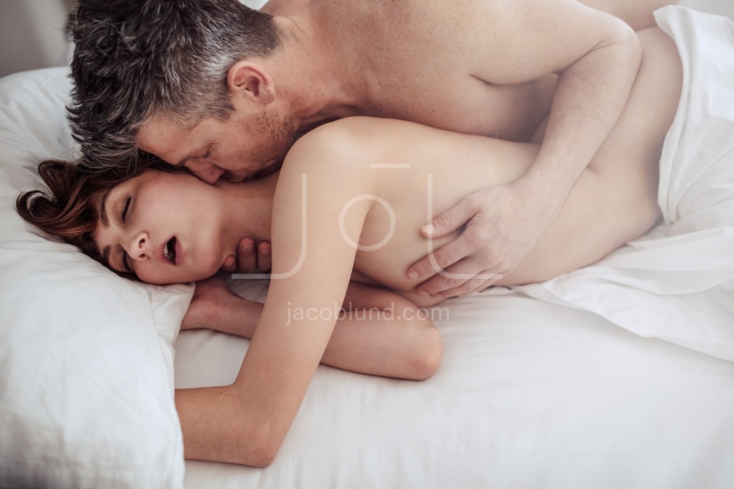 Man and woman in bed having intimate pic