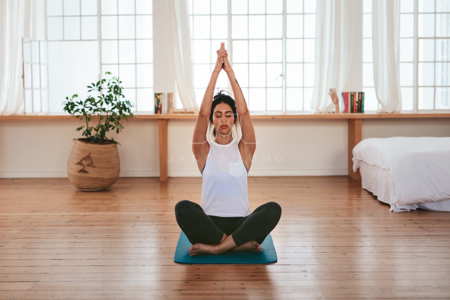 Beautiful young woman relaxing at home in yoga position – Jacob Lund  Photography Store- premium stock photo