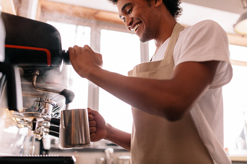 Smiling barista making espresso with a coffee maker – Jacob Lund  Photography Store- premium stock photo