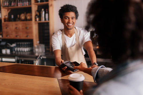 Smiling barista making espresso with a coffee maker – Jacob Lund  Photography Store- premium stock photo