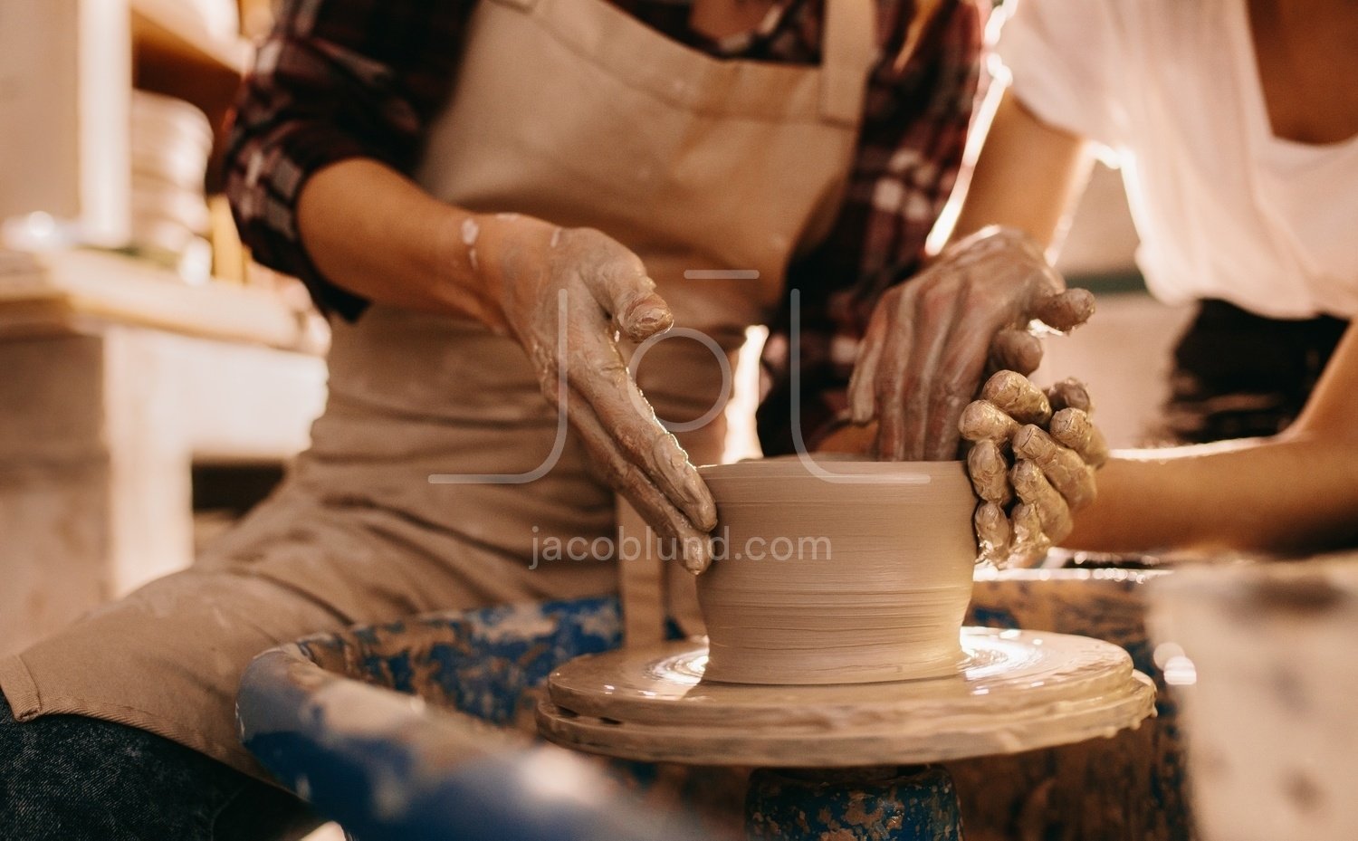 Premium Photo  Potter making a clay object on pottery wheel in