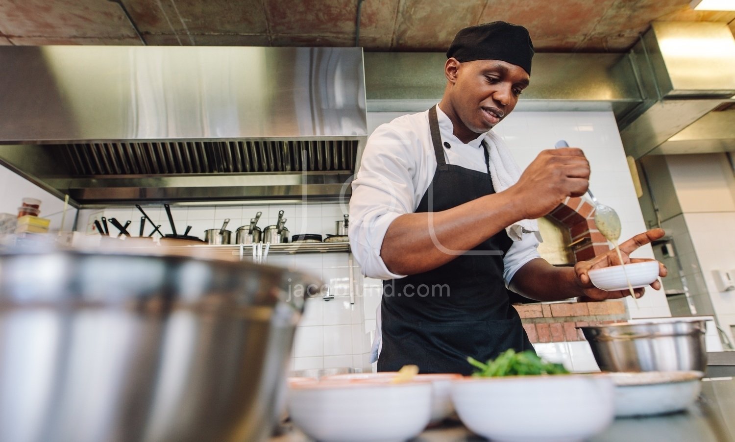 Gourmet chef cooking in a commercial kitchen – Jacob Lund Photography  Store- premium stock photo