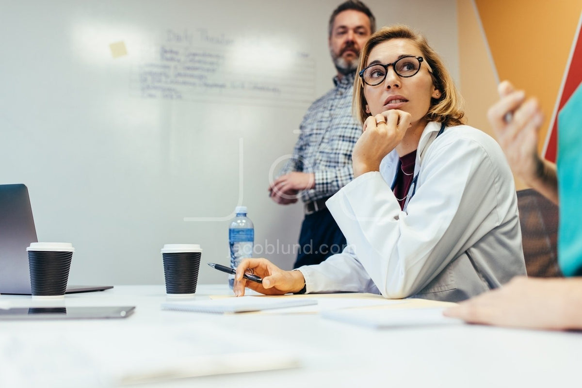 Team Of Medical Professionals Meeting In Boardroom – Jacob Lund ...