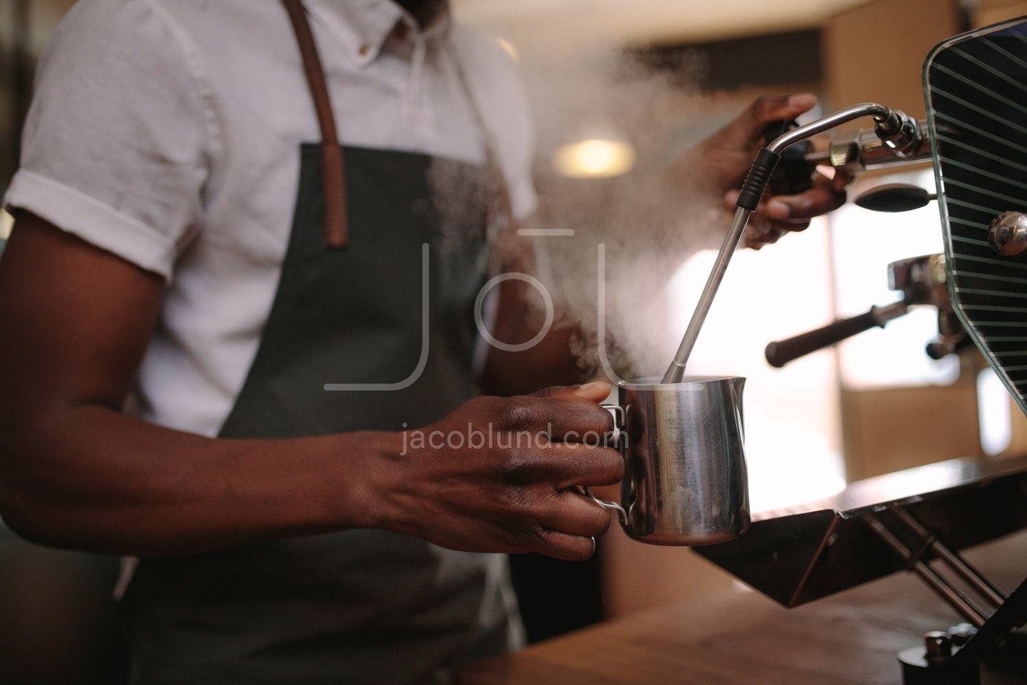 Smiling barista making espresso with a coffee maker – Jacob Lund  Photography Store- premium stock photo