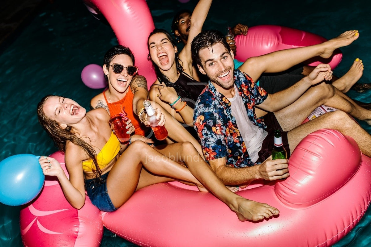 Happy people enjoying swimming pool party - UpLabs