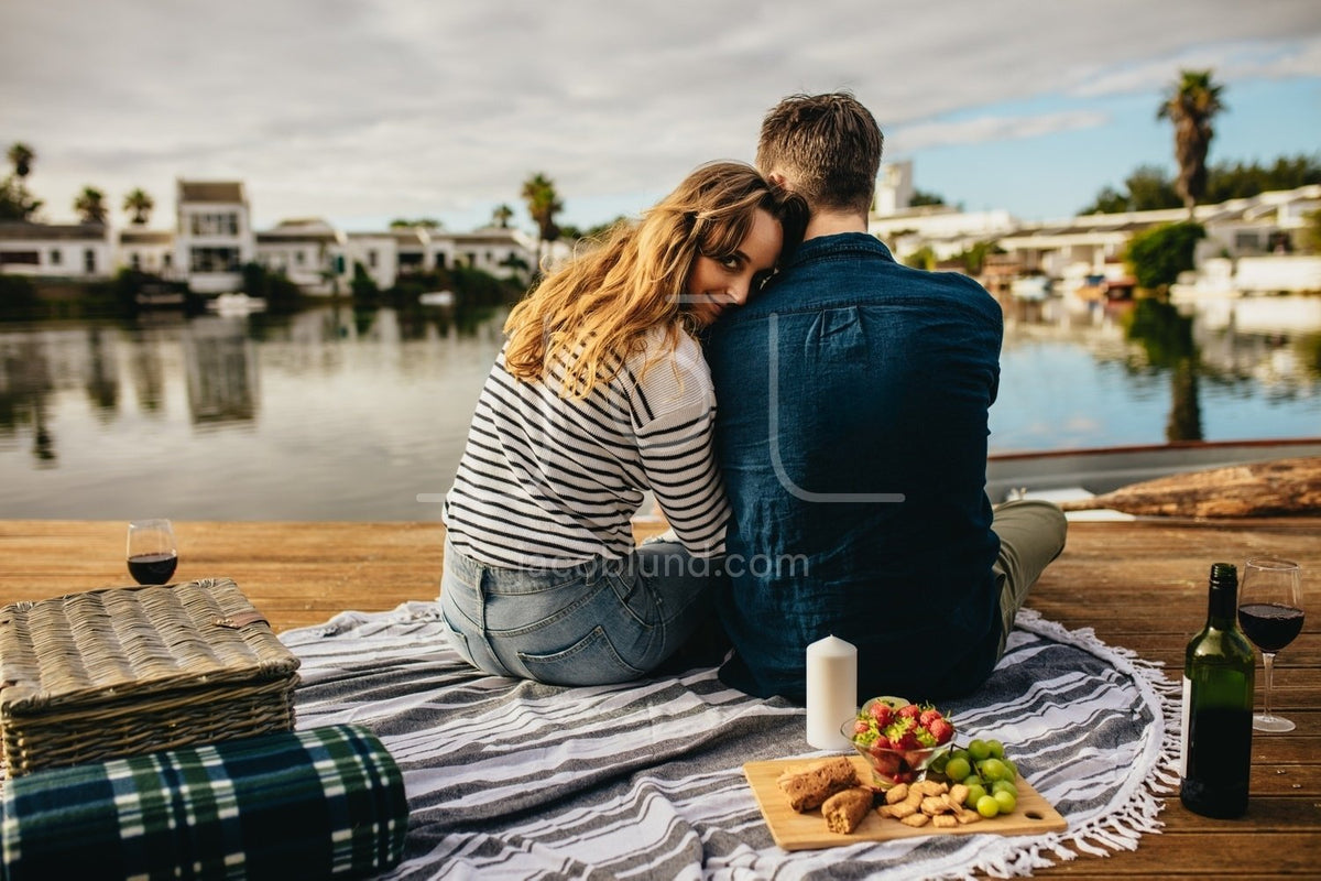 https://jacoblund.com/cdn/shop/products/photo-id-2007250403397-romantic-couple-on-a-date-sitting-near-a-lake-with-snacks_1200x800.jpg?v=1563891569