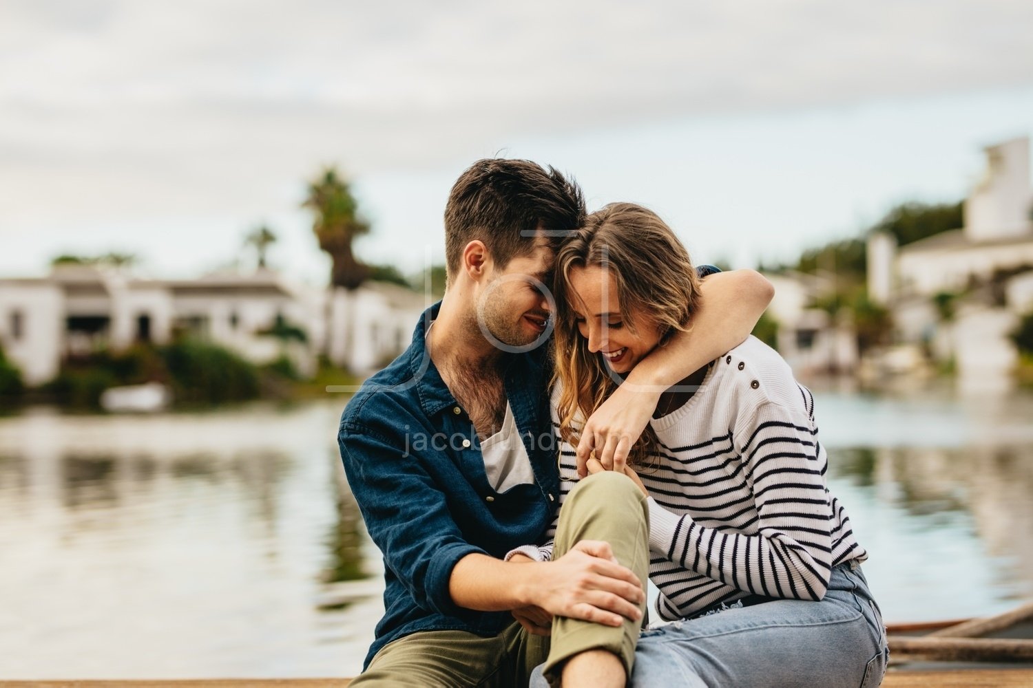 Couple sitting outdoors near a lake in a romantic mood – Jacob Lund  Photography Store- premium stock photo
