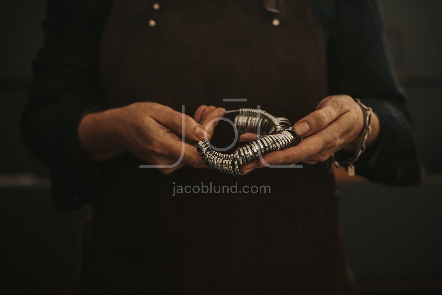 Jeweler holding ring measurer tool – Jacob Lund Photography Store