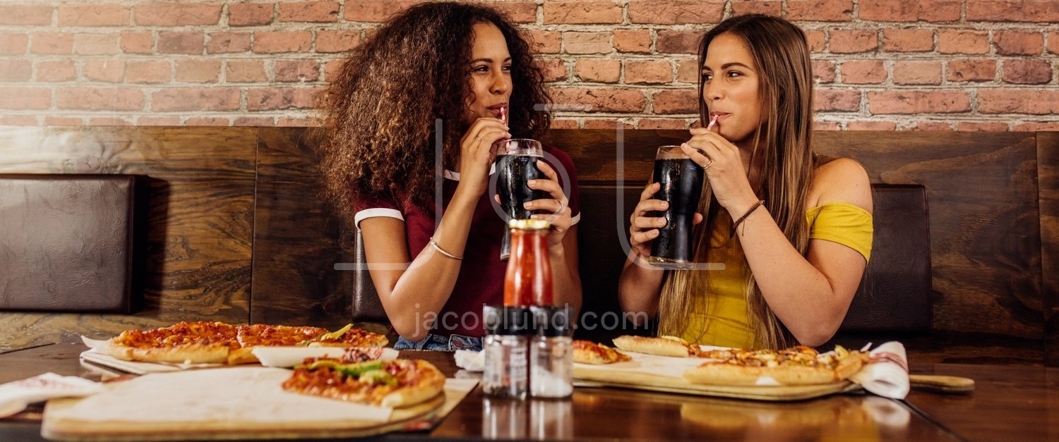 Best Friends Enjoying Drinking Cola At Cafe Jacob Lund Photography