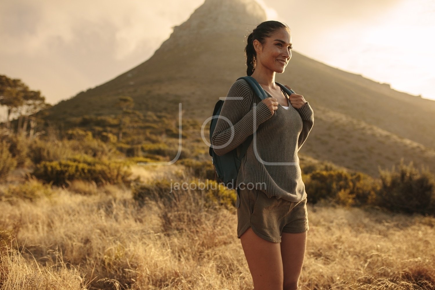 Woman Hiking In Mountains And Looking At The Scenic View