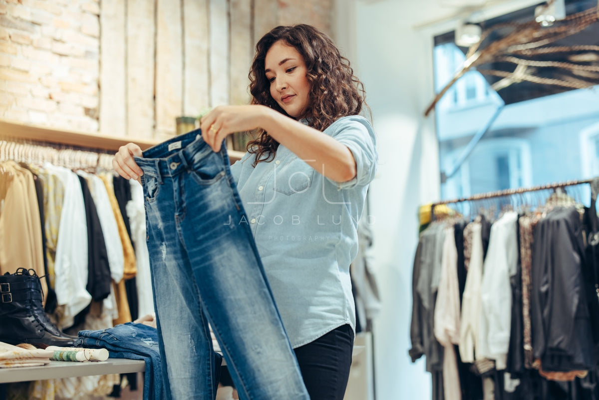 Young Woman Pleases Buying Jeans In Women's Clothing Store Stock Photo,  Picture and Royalty Free Image. Image 78820273.