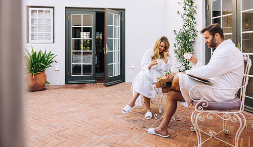 Cute couple having coffee in a luxury hotel room – Jacob Lund