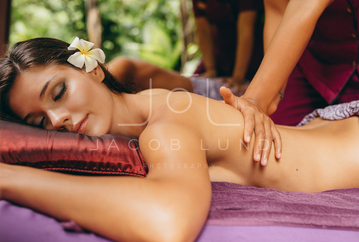 Woman getting back massage at spa resort – Jacob Lund Photography